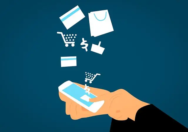 grafica in cui sono rappresentate due mani che utilizzano uno smartphone. Da questo fuoriescono vari elementi come un carrello, una carta di credito, il simbolo del dollaro.